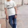 A-man-wearing-a-tee-and-leaning-on-a-pillar