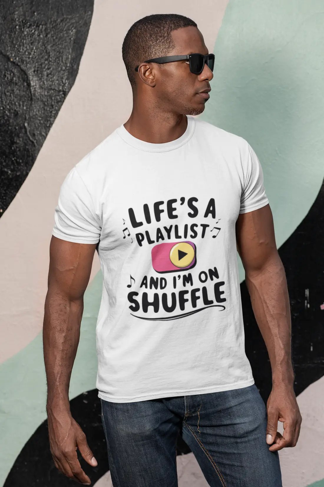 a-man-with-sunglasses-wearing-a-customizable-t-shirt-against-a-painted-wall